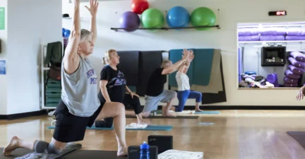 Older Adult practicing Vinyasa Yoga