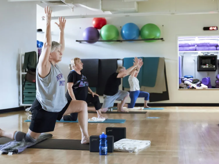Older Adult practicing Vinyasa Yoga