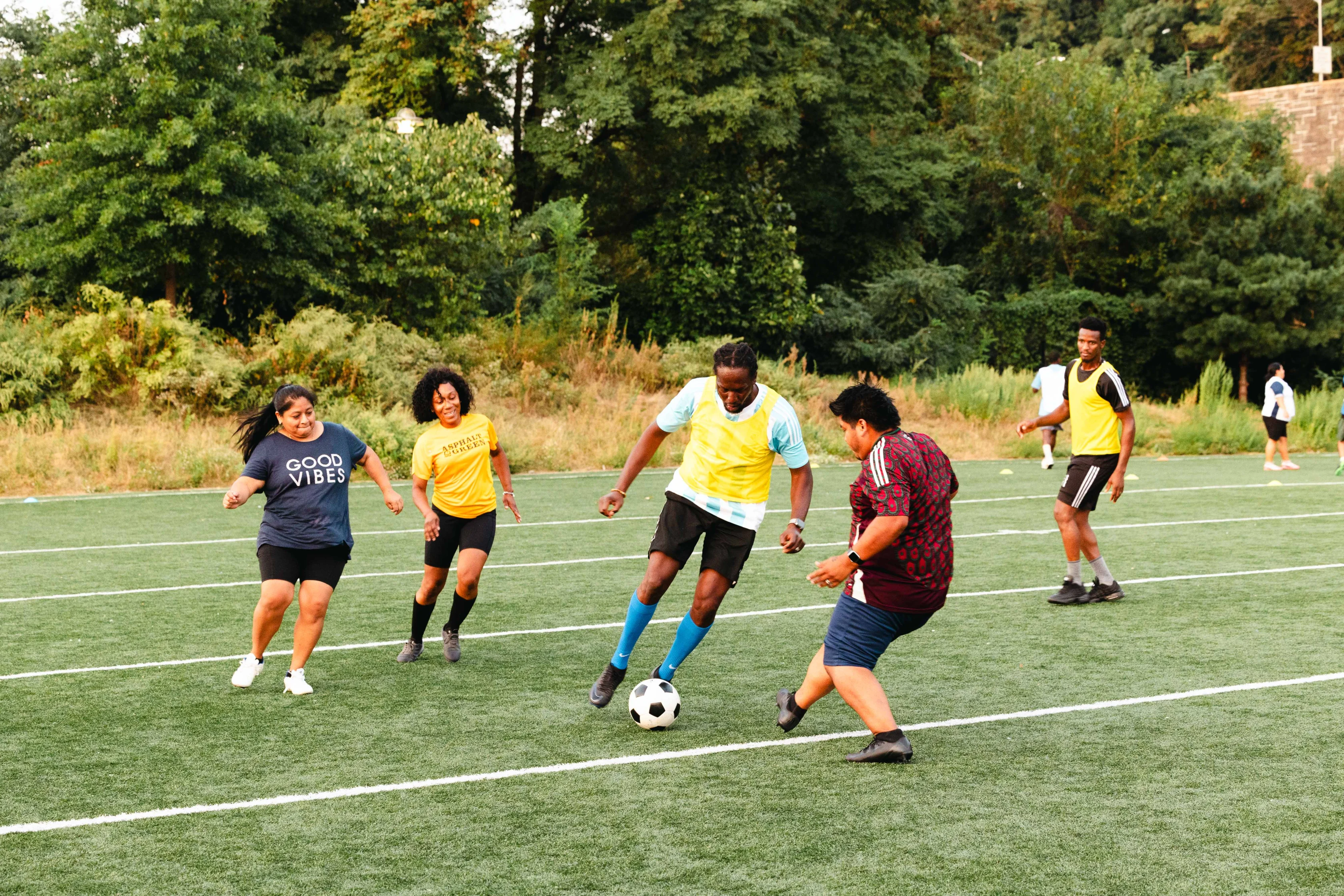Kimberly, pictured in yellow, takes the field in an adult league scrimmage