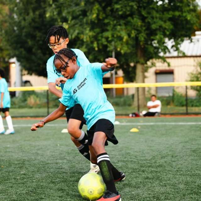 Two young athletes stay active in an Asphalt Green Soccer Club program.